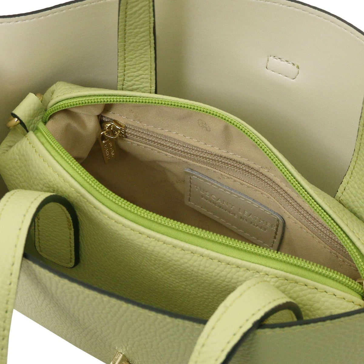 Interior top view of lime tote showing a zip pocket and an inner label
