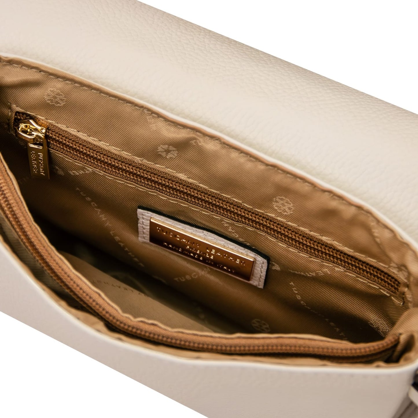 Inside of the Biscuit soft leather shoulder bag with tan lining a zip pocket and brand plaque.