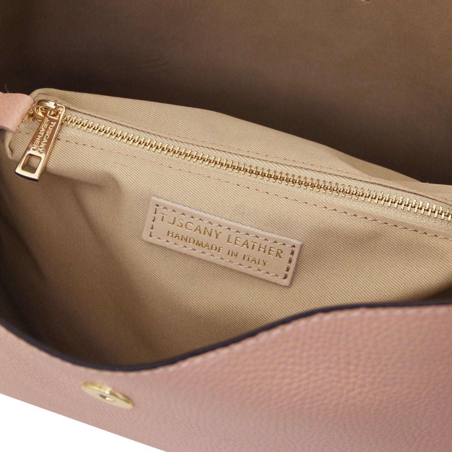 Beige pebbled leather bucket bag interior with a gold zipper and Tuscany Leather Handmade in Italy label