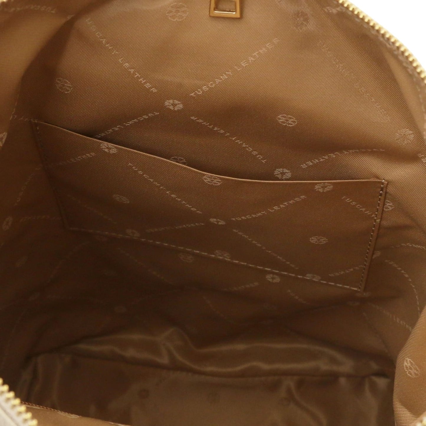 Interior view of Dublin Soft Italian leather backpack with brown lining and a slip pocket.