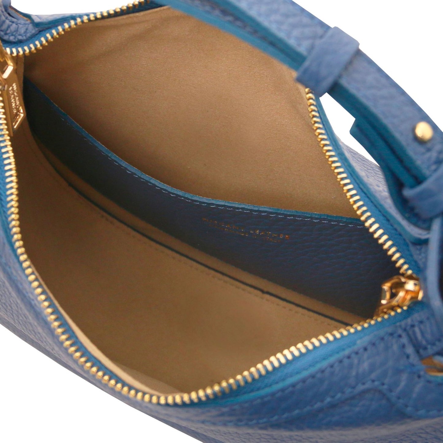 Interior view of the blue Hoblò bag showing beige lining and a blue pocket with gold zipper