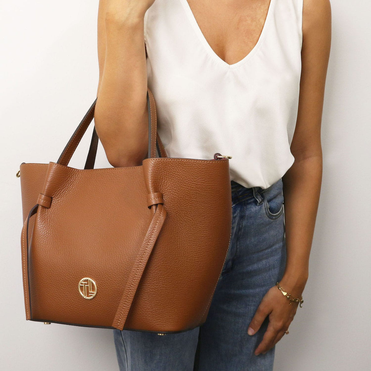 Legame - Italian leather shopping bag - Large size | TL142481 in brown pebbled leather with dual top handles and gold-tone circular hardware held against a white top.