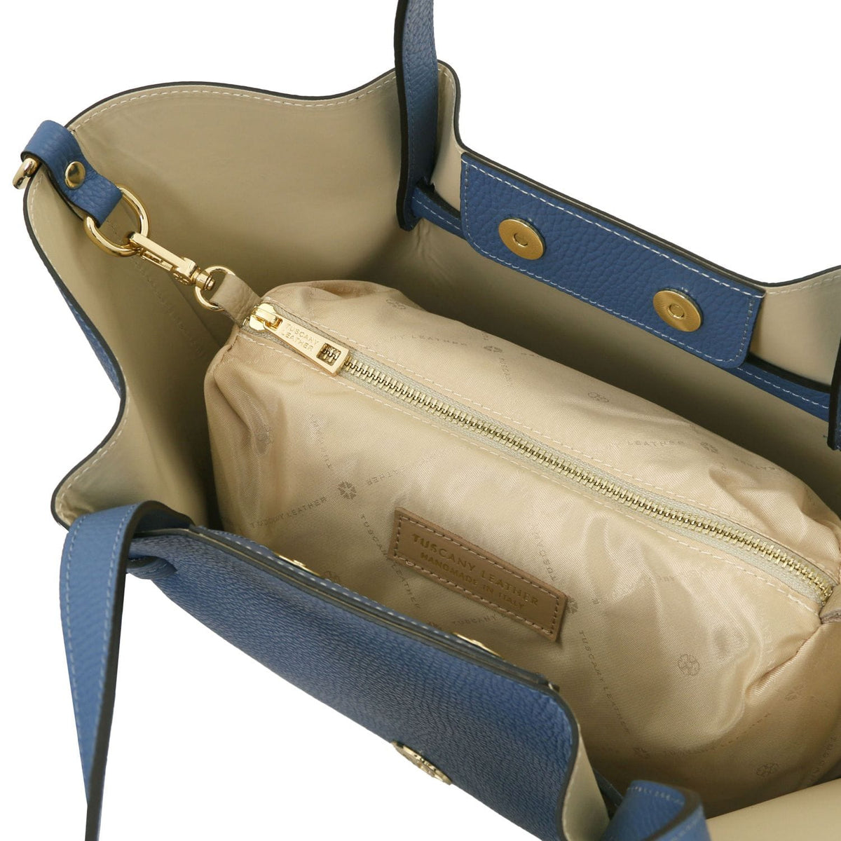 Beige interior lining of blue Legame bag with zip pocket and Tuscany Leather label.