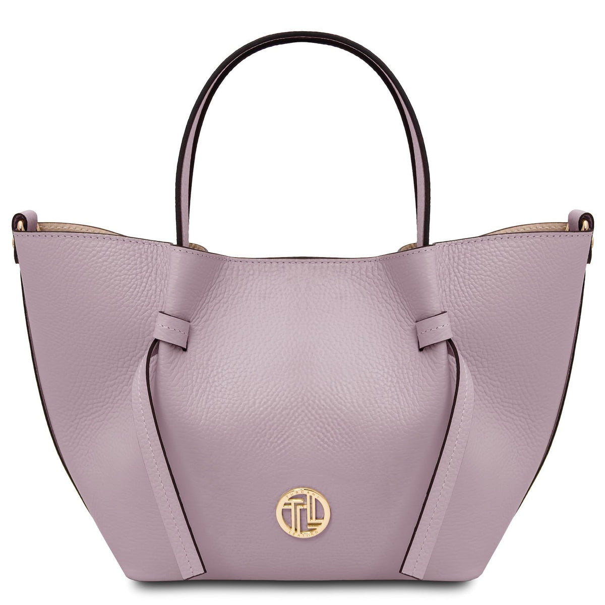 Front view of lavender Legame leather handbag with top handle and gold emblem on the front