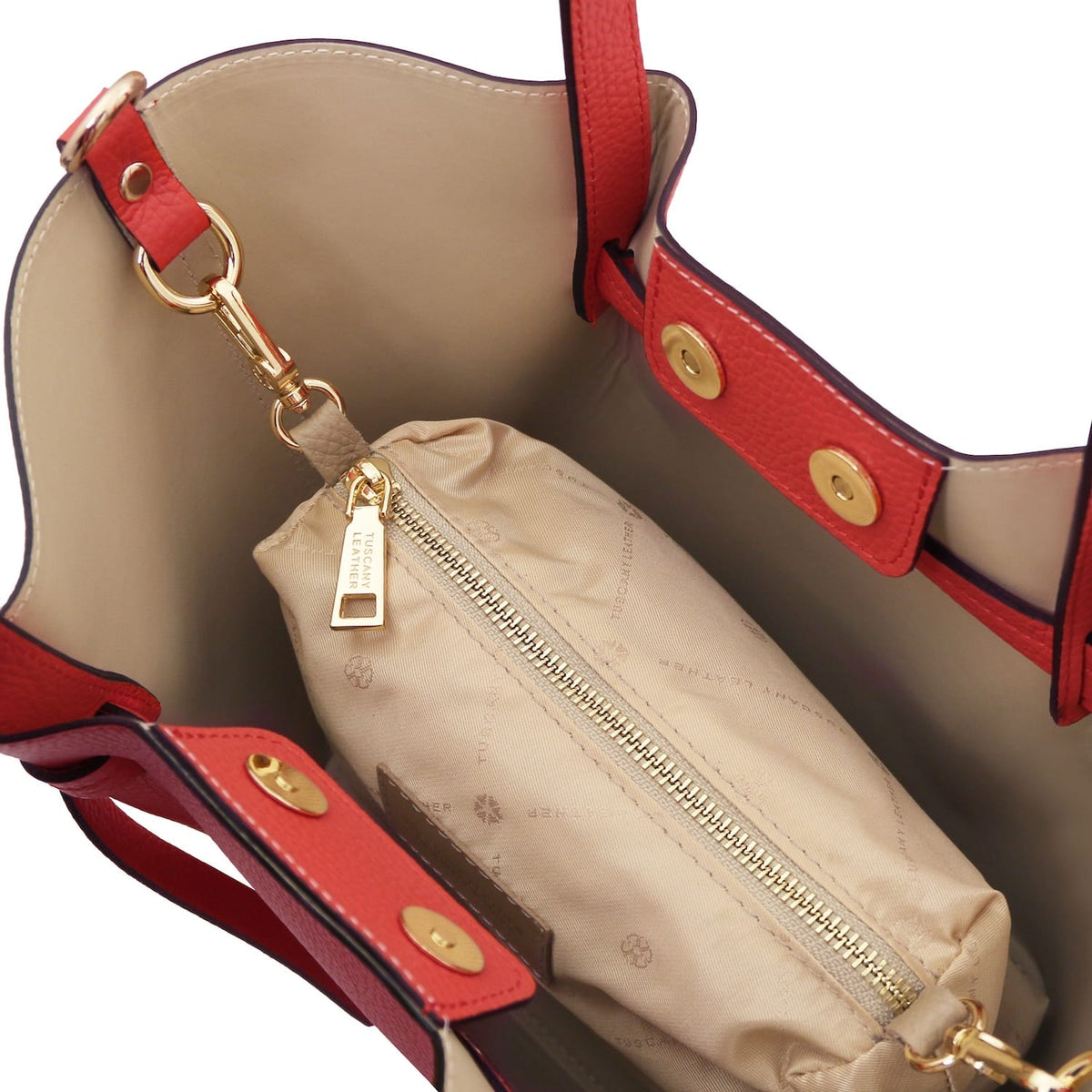 Interior view of red Legame leather handbag with beige lining and a zip pouch inside