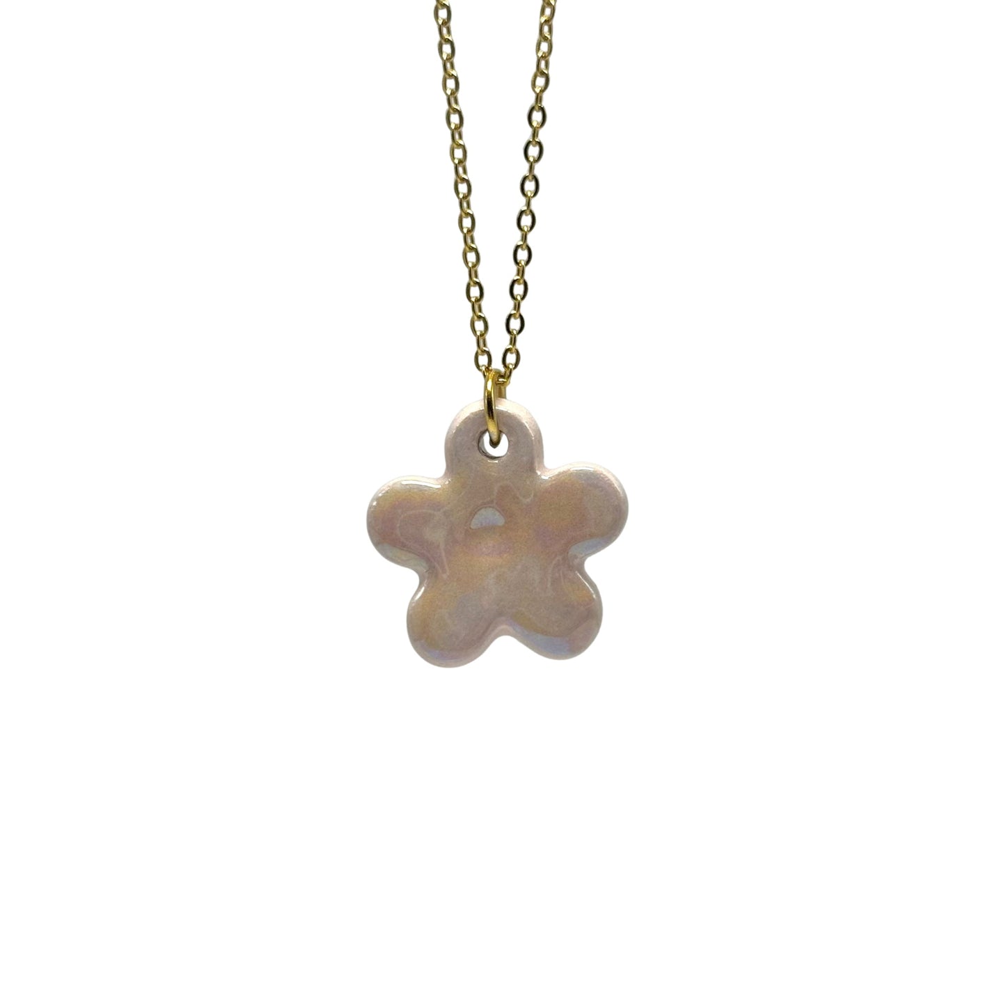 Lillium handcrafted pink pearlescent flower ceramic necklace hanging from a gold chain