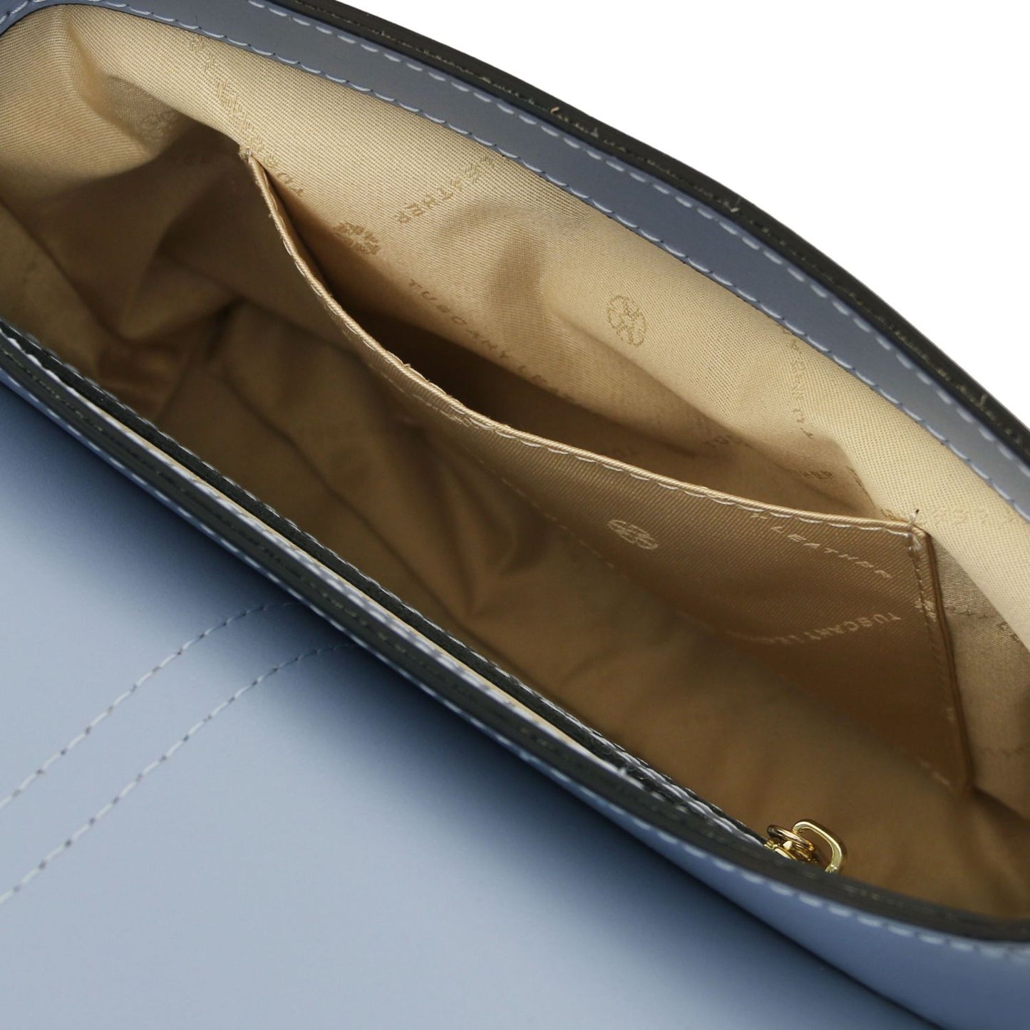 Interior of the Nausica bag with beige lining and a stitched slip pocket along the side
