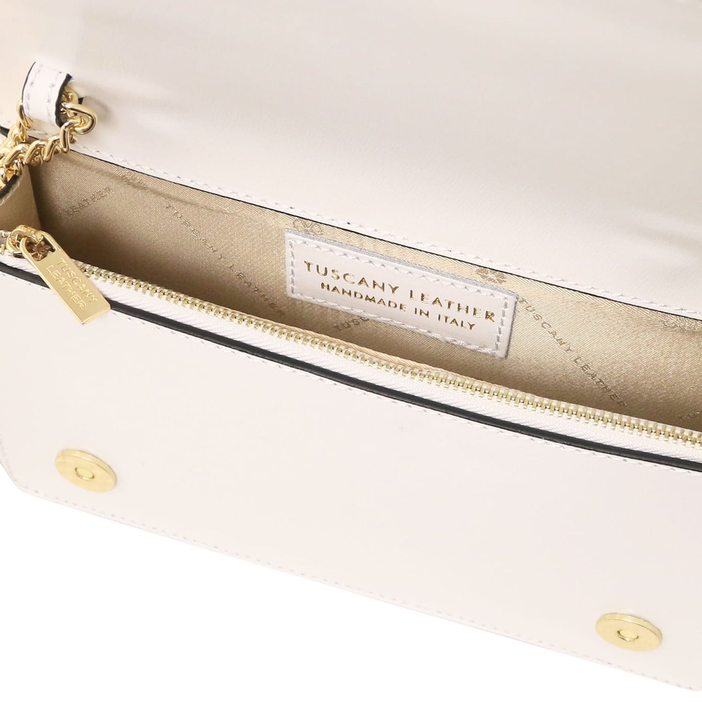 White leather clutch with a gold chain strap and a gold zipper, interior label visible.