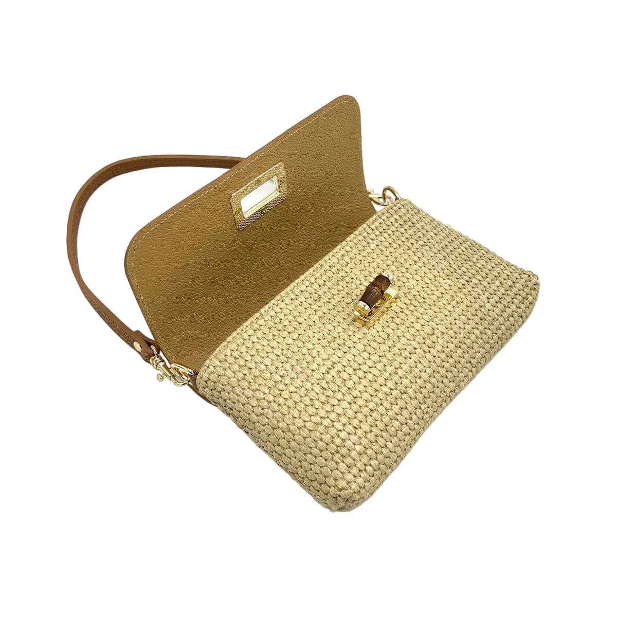 Raffia and leather shoulder bag with the cognac flap open, showing the woven raffia body and gold clasp.