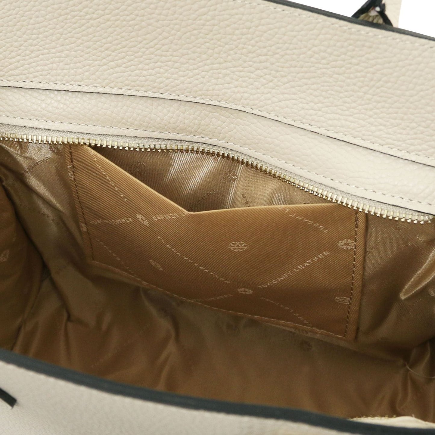 Interior of beige leather tote with tan lining and a zippered pocket