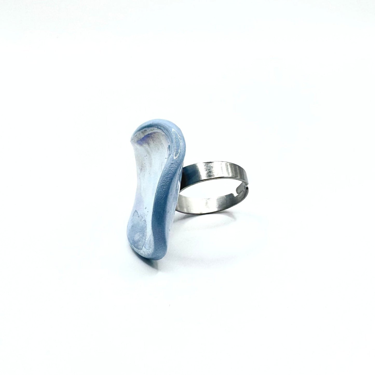 Handcrafted light blue ceramic ring with curved pebble shape and a silver band