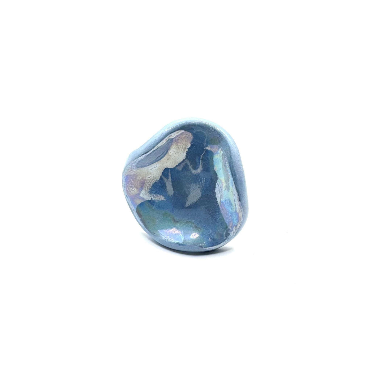 Close-up of a single light blue pearl ceramic ring with an irregular rounded shape on a white surface.