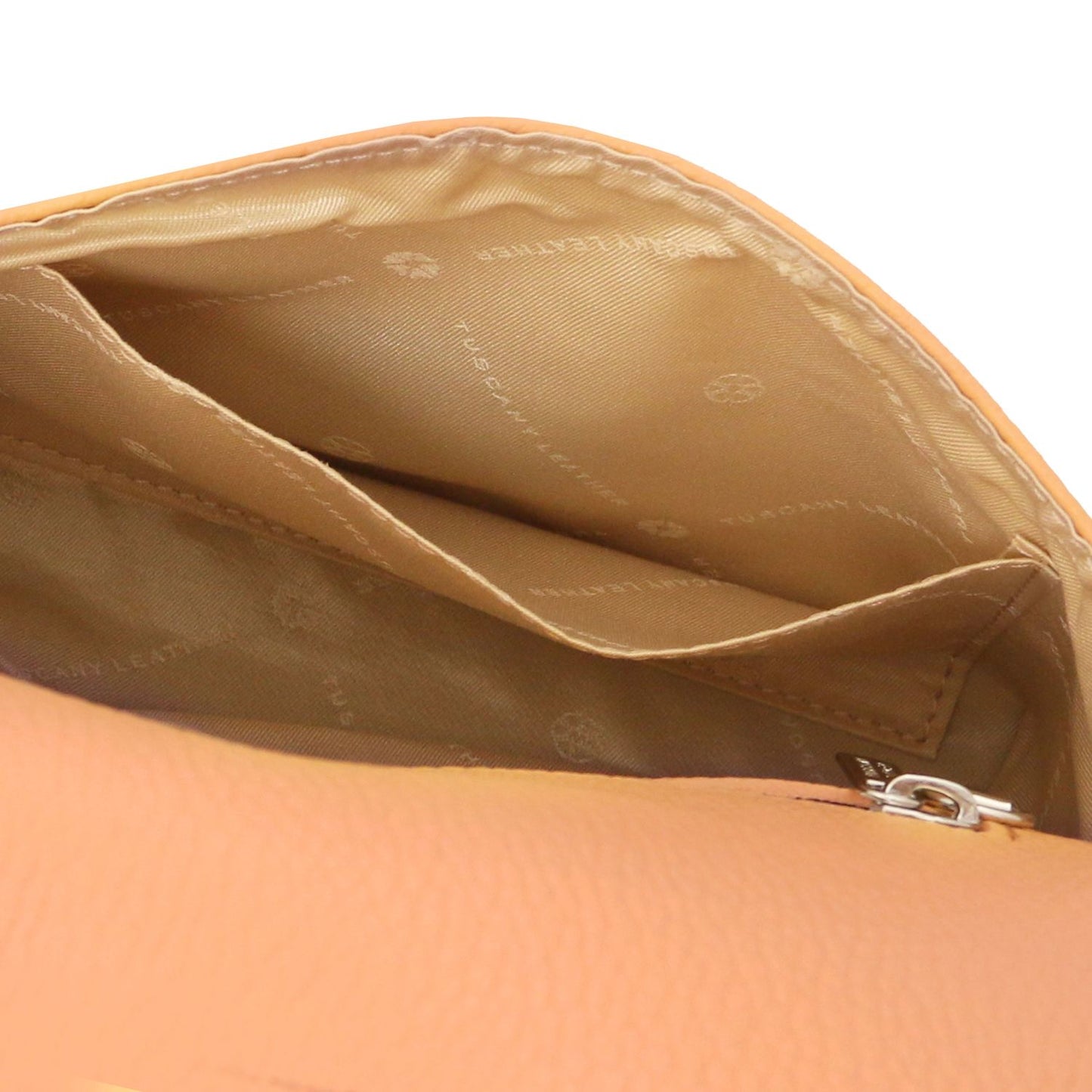 Inside view of tan leather foldover clutch with stitched pockets and beige lining.