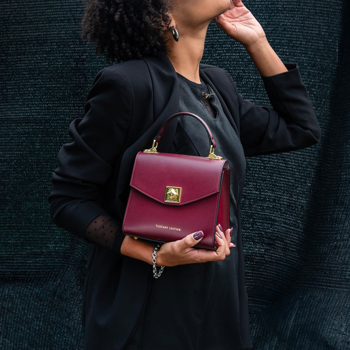 Burgundy leather mini bag with top handle and gold turn-lock clasp