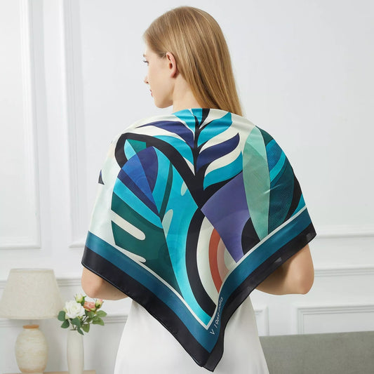 Toucan Large Square Silk Scarf | Blue (90 × 90 cm) draped showing abstract blue and teal geometric patterns with black border.