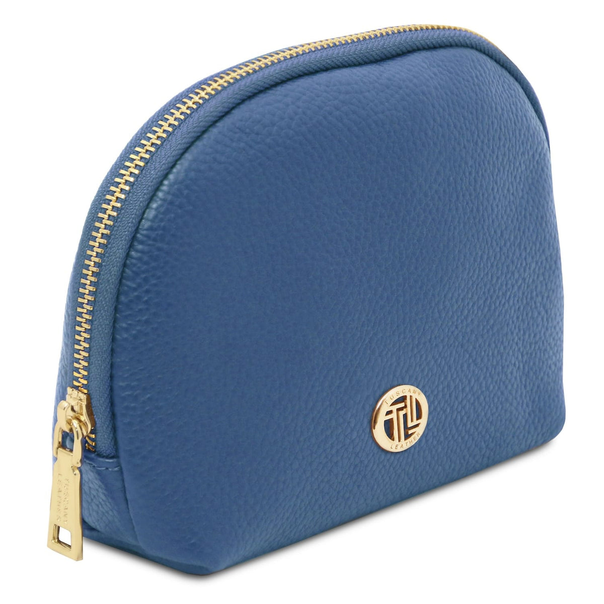Blue cuir souple toiletry case with gold-tone zipper and round metal emblem on pebbled Italian leather surface.