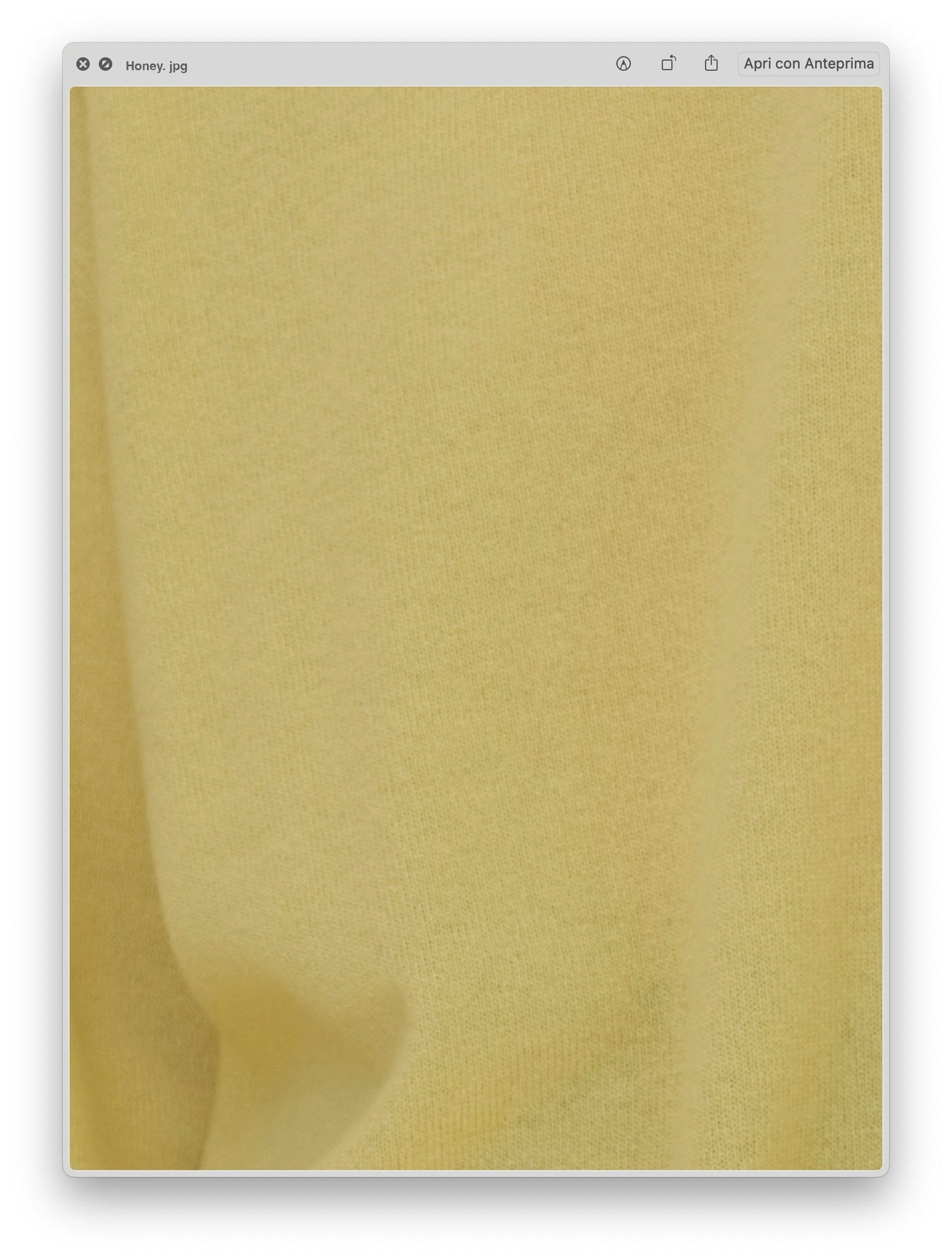 Close-up of pale yellow knit fabric texture