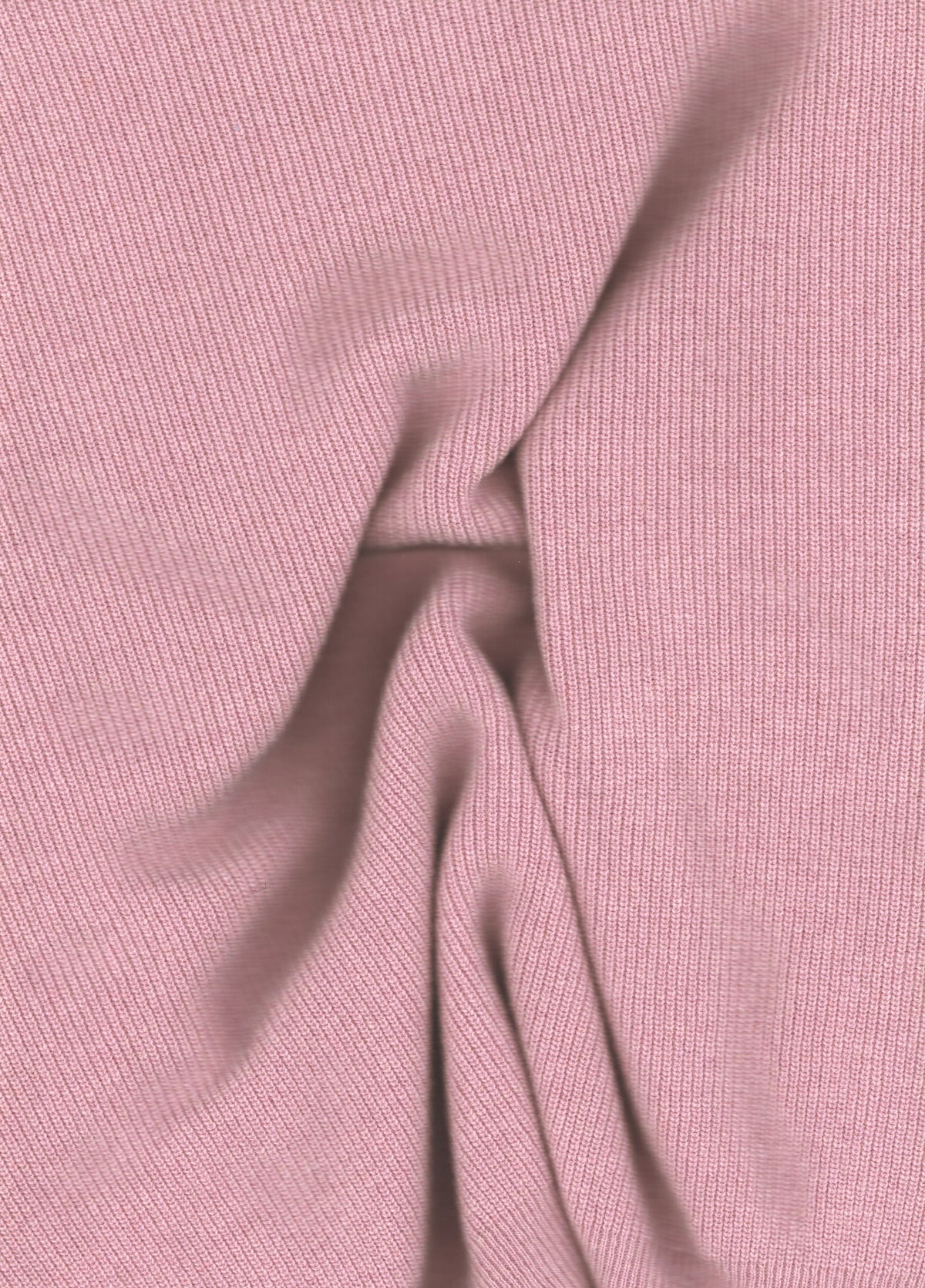 Close-up of soft pink ribbed knit fabric from a wool and cashmere mix high neck sweater