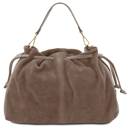 A taupe brown suede drawstring bag with a single shoulder strap and gold-tone hardware, shown against a plain white background.