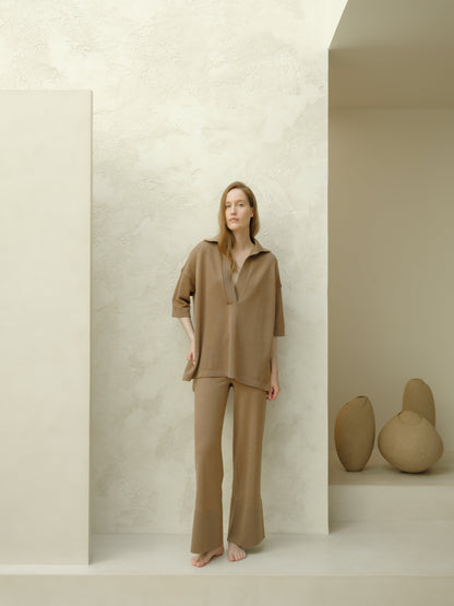 Model wearing taupe Extra Fine Merino Wool Maxi Polo set with an oversized top featuring three-quarter sleeves and wide-leg pants.