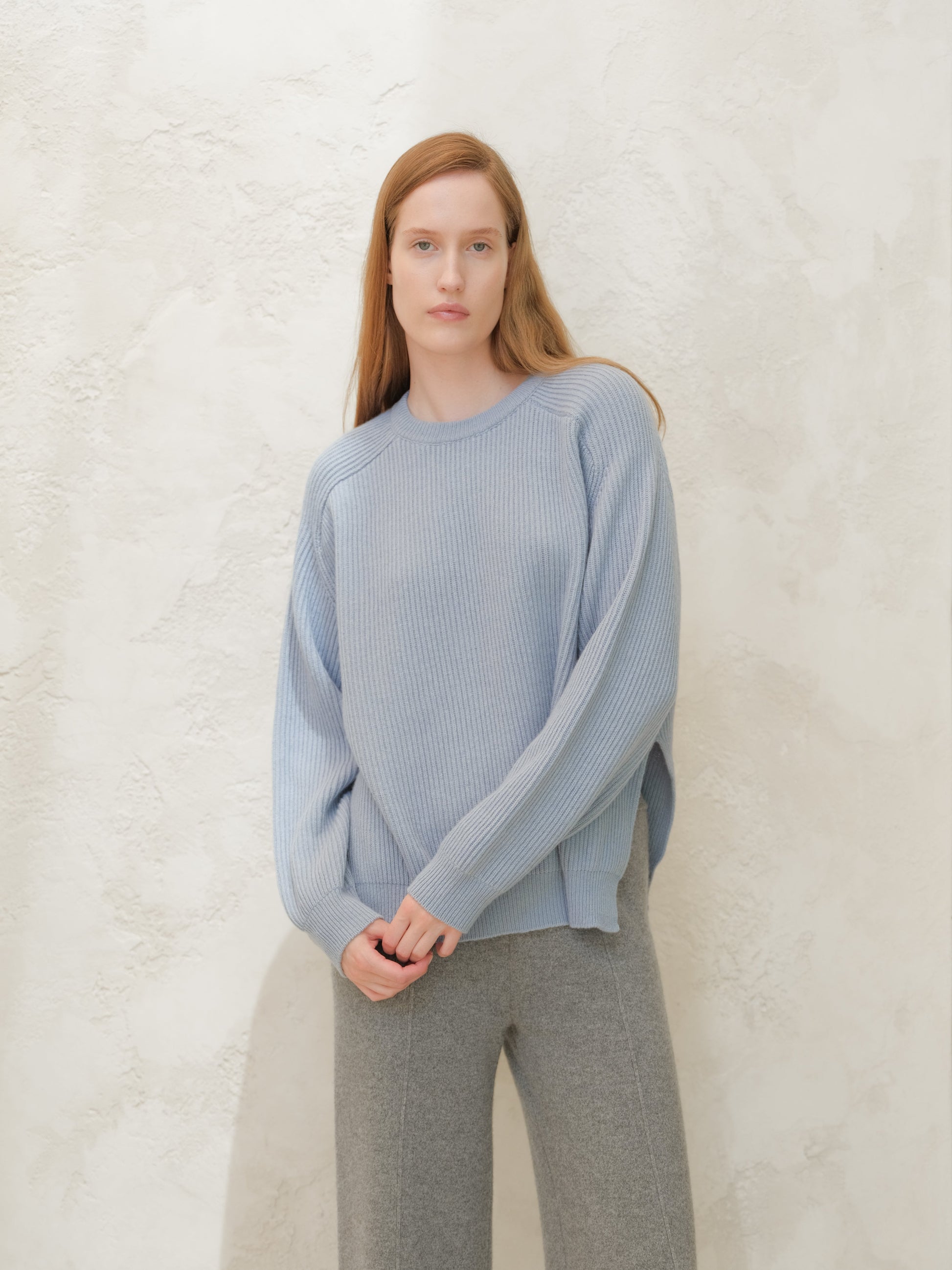 Model wearing a light blue cashmere mix crewneck ribbed sweater