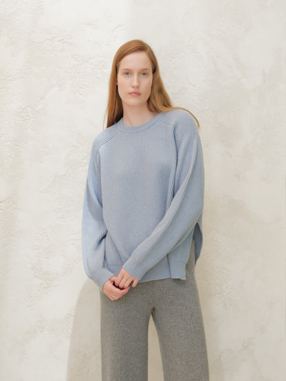 Model wearing a light blue cashmere mix crewneck ribbed sweater