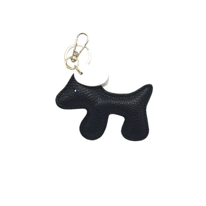 Black dog-shaped keychain on a white background
