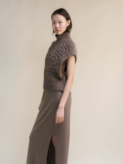 Taupe cashmere mix maxi cable tunic worn by a model with a high neck and sleeveless oversized armholes