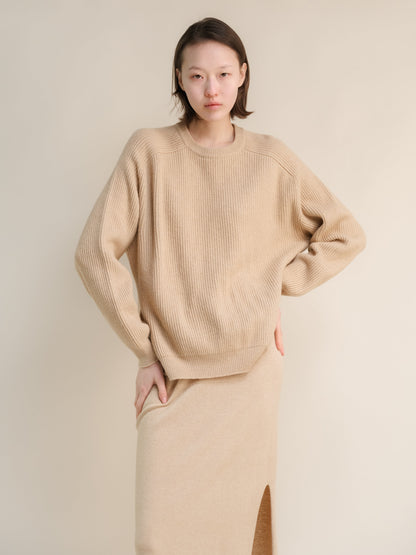 Beige cashmere mix crewneck ribbed sweater worn by a model in a relaxed oversized fit