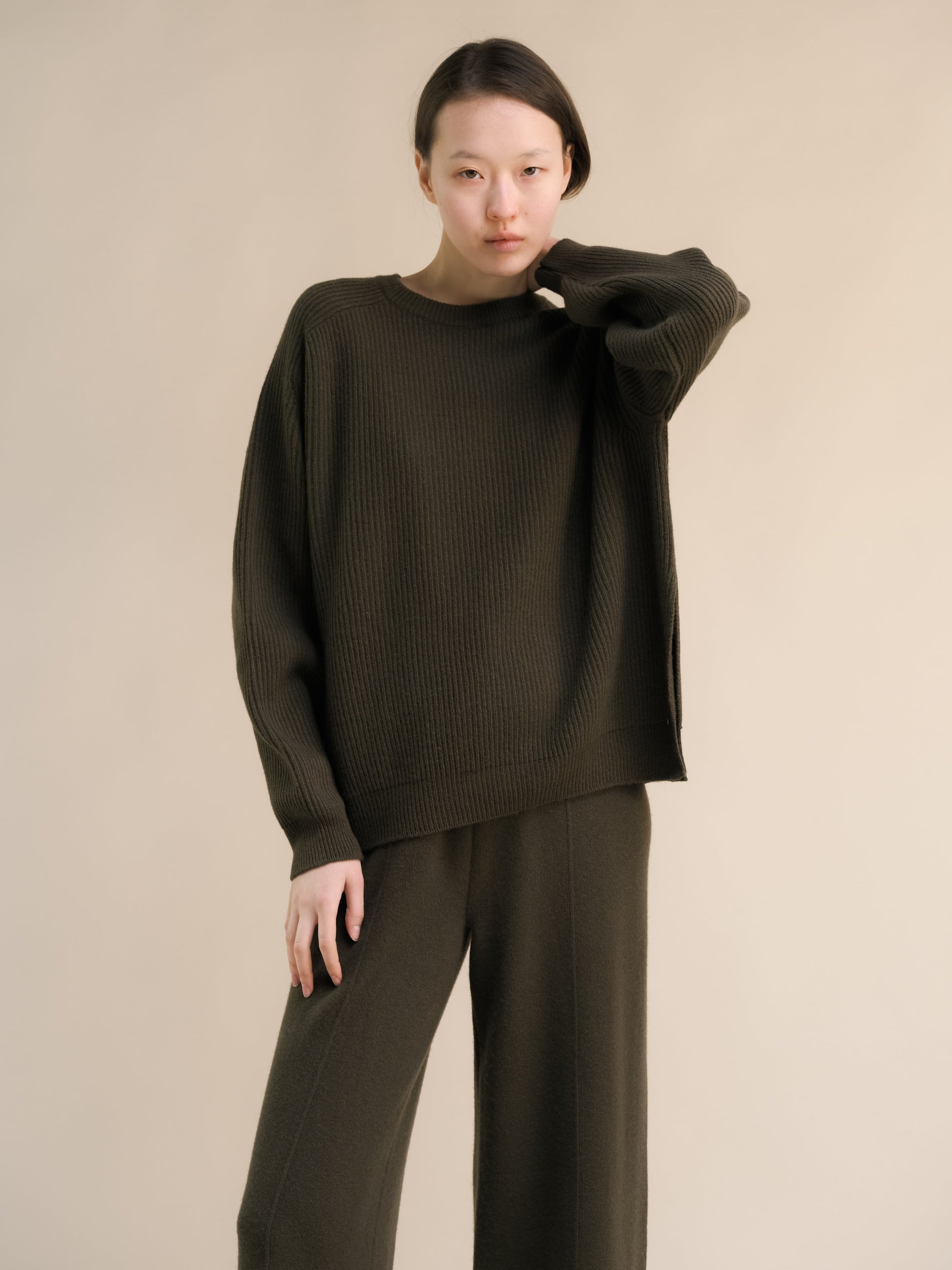 Dark olive cashmere mix ribbed crewneck sweater on model with relaxed oversized fit