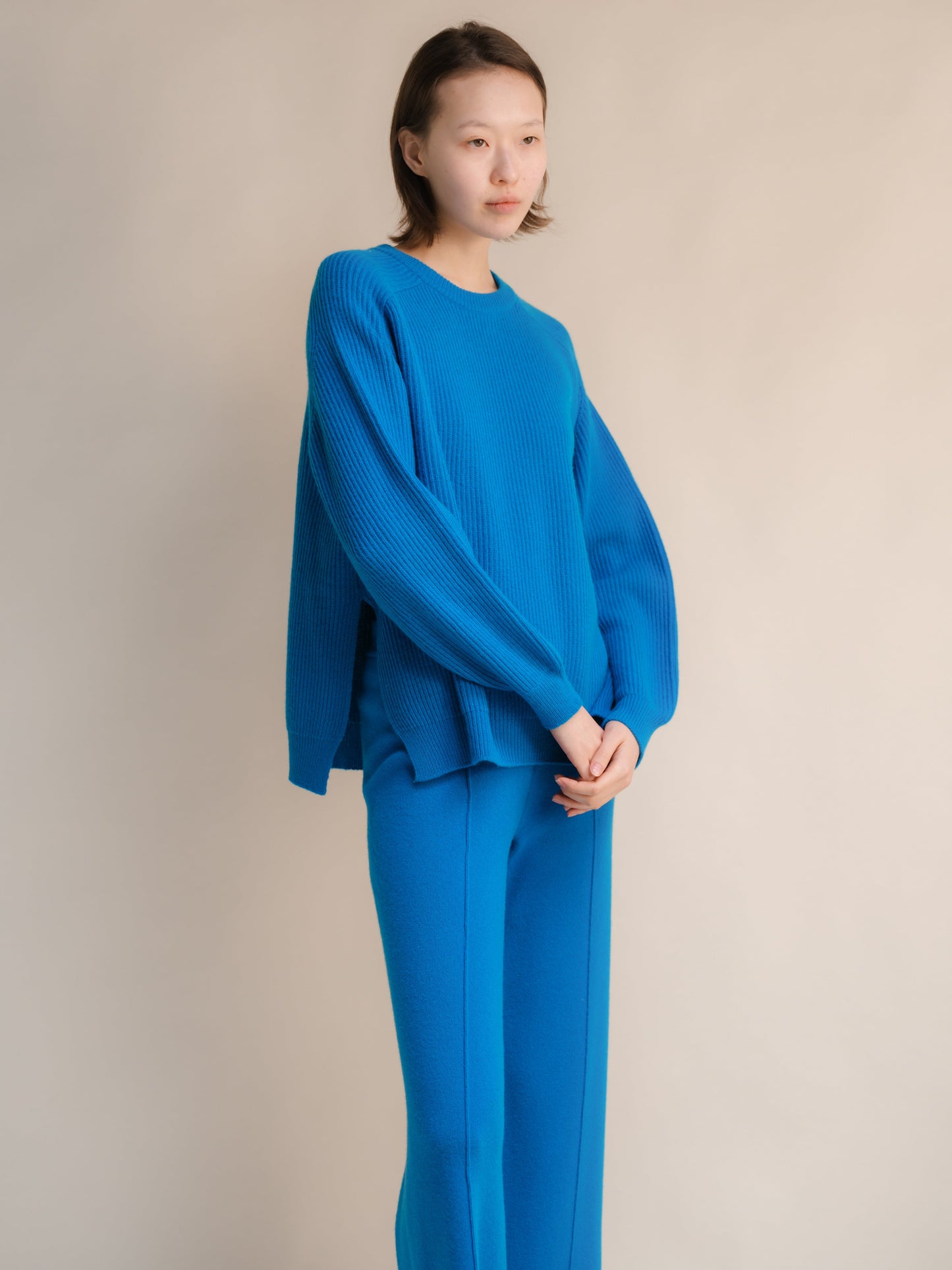 Bright blue cashmere mix ribbed crewneck sweater on a model with relaxed fit