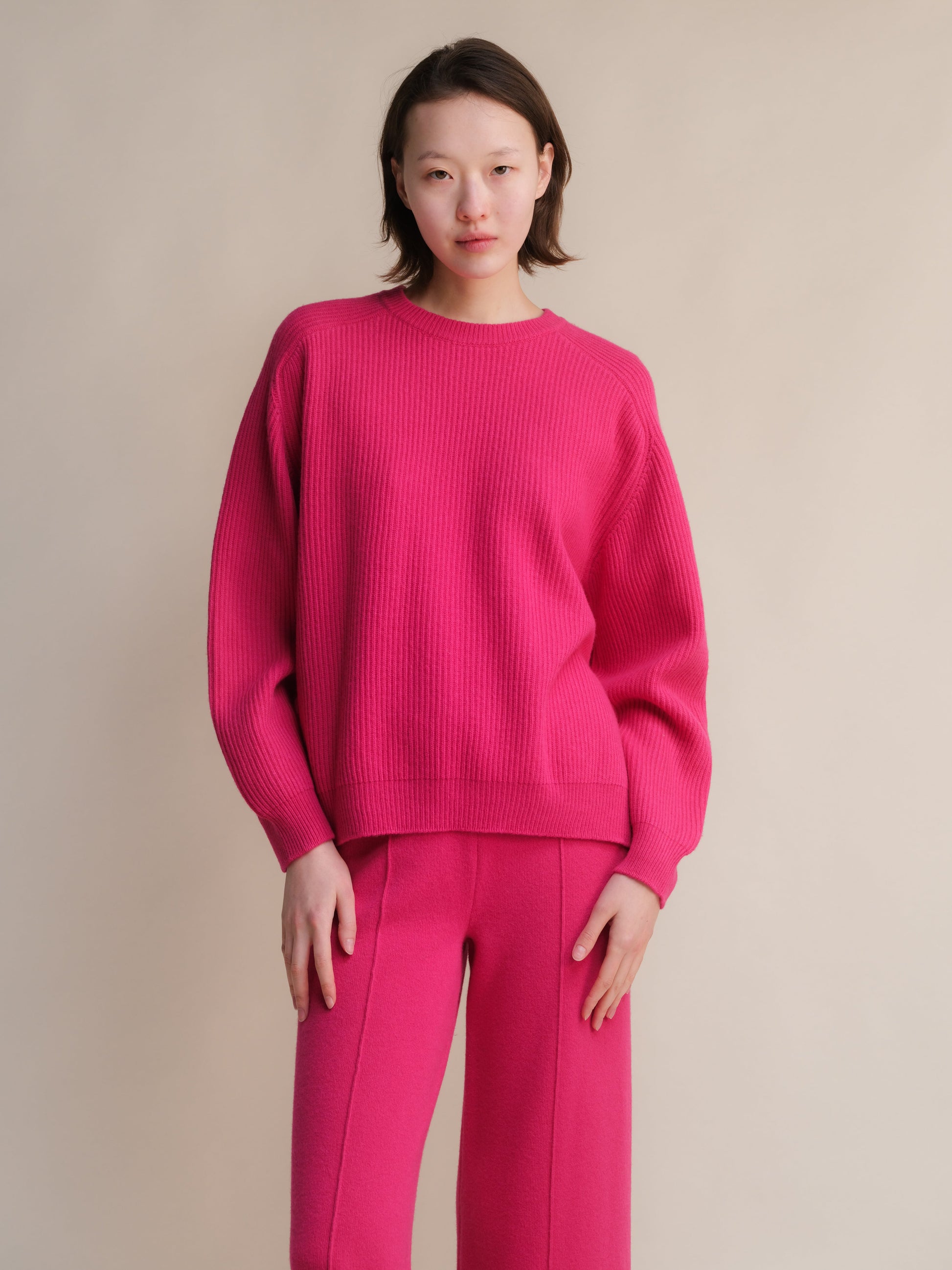 Bright pink cashmere mix ribbed crewneck sweater with side slits