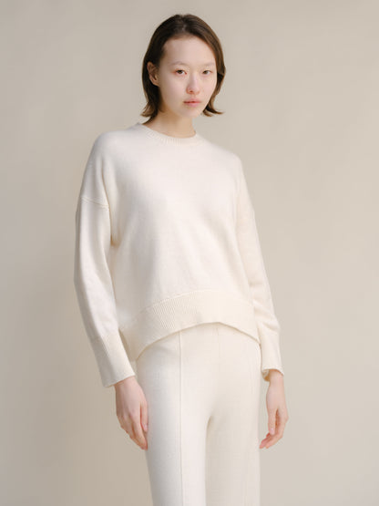 Model wearing white cashmere mix crewneck sweater, front view
