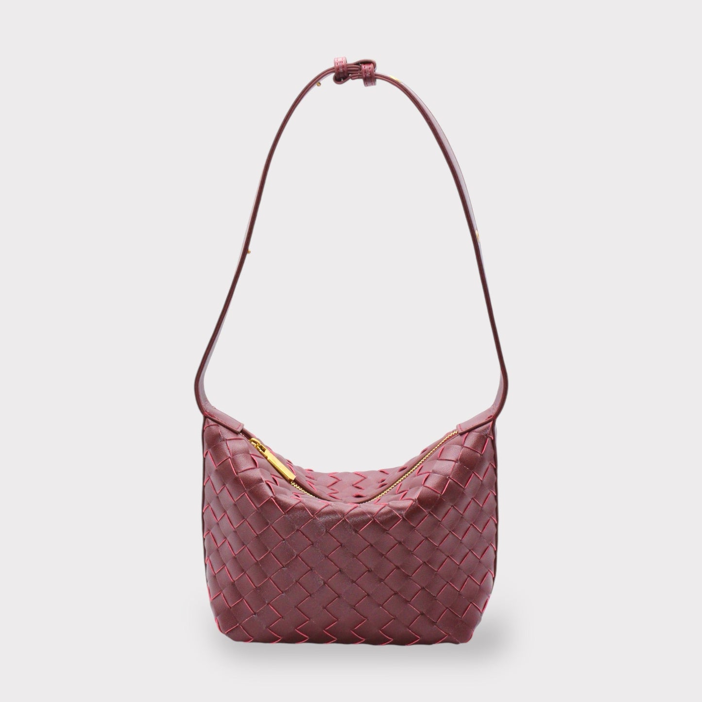 Genuine leather woven style boxed pouch bag in burgundy with a gold zipper and long shoulder strap