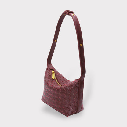 Genuine leather woven style boxed pouch bag in burgundy with a gold zipper and long shoulder strap