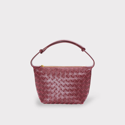 Wine burgundy woven leather boxed pouch bag with an arched Tragegriff and gold zipper.