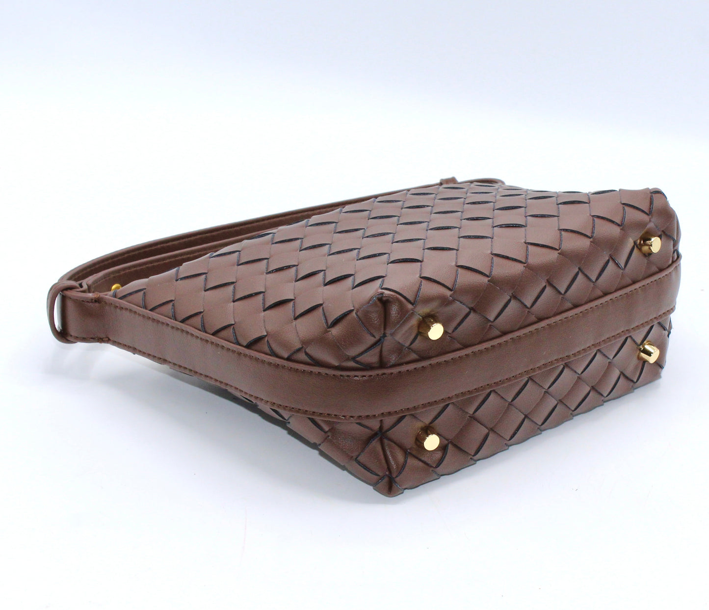 Genuine leather woven boxed pouch bag in brown with gold studs at its base, shown from the side.