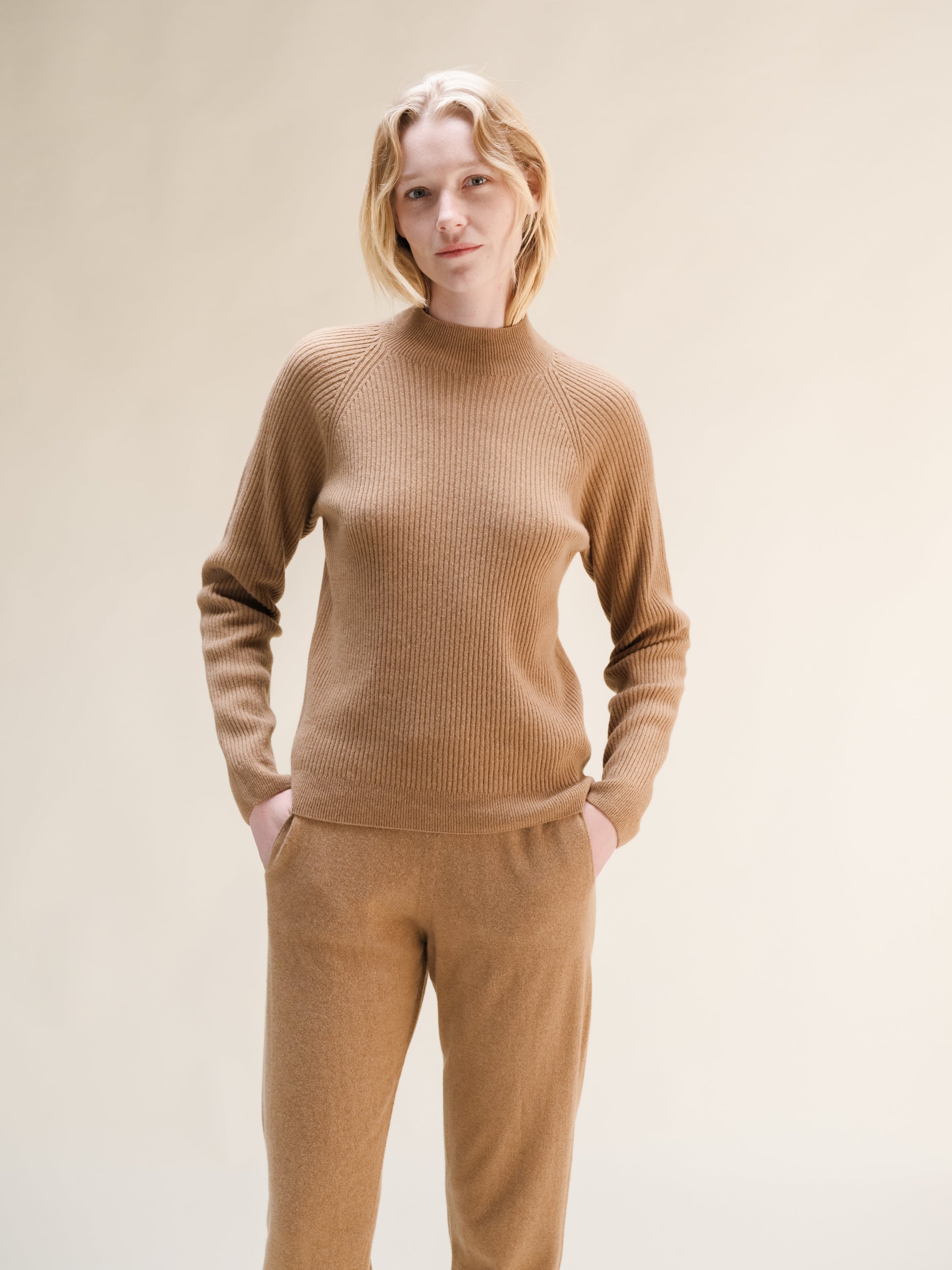 Beige cashmere mix ribbed mock neck sweater worn by model