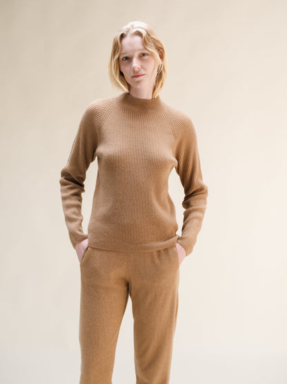 Beige cashmere mix ribbed mock neck sweater worn by model