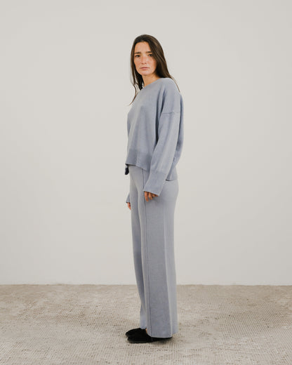 Light blue oversized cashmere mix crewneck sweater worn by a model in a side pose.