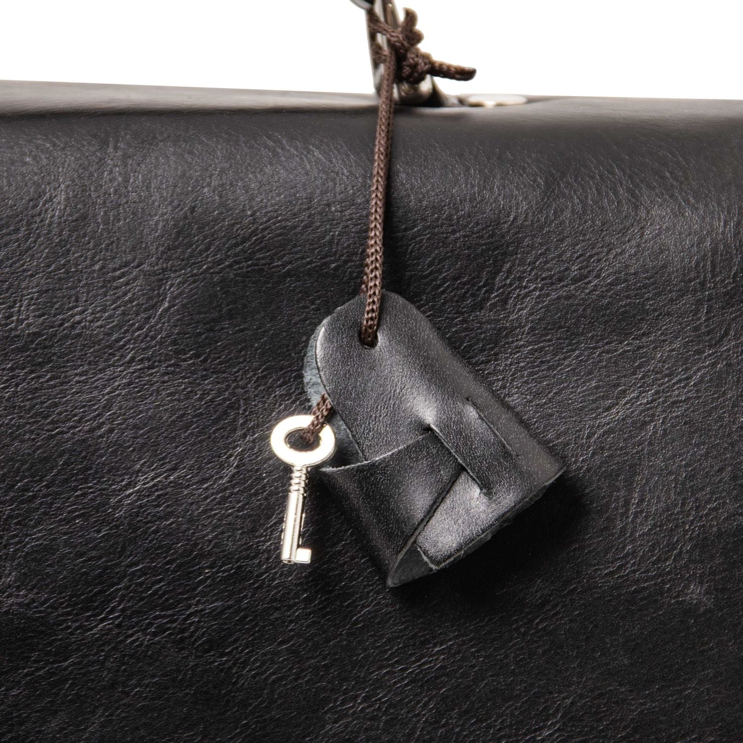 Alessandria matte leather laptop briefcase close-up with a leather tag and key on a brown cord