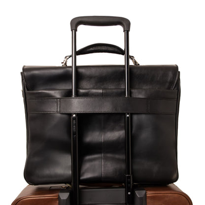 Matte black leather laptop briefcase mounted on a rolling suitcase with an extended telescoping handle