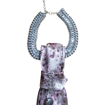 Chunky silver chain necklace draped around a floral purple 4-in-1 Jeweled Tie.