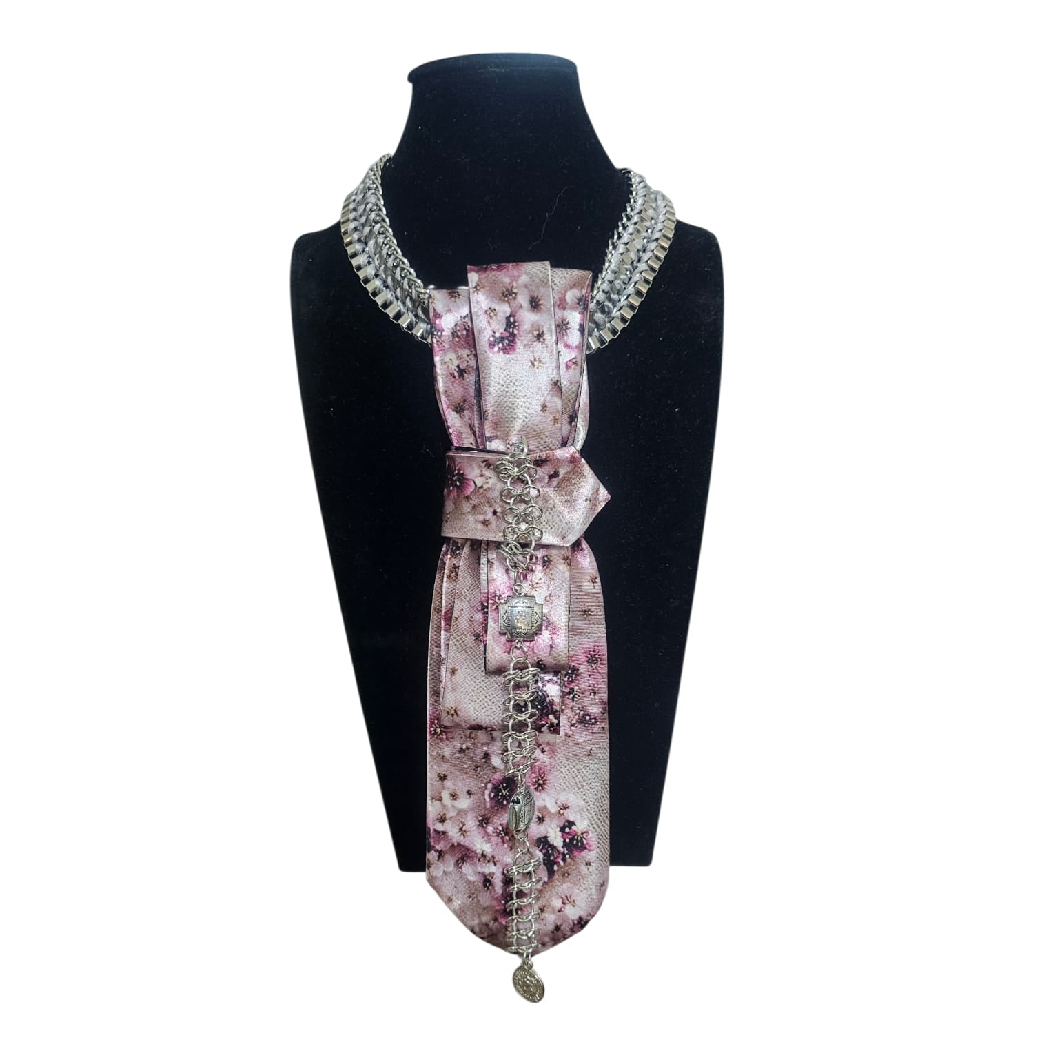 Pink cherry blossom patterned 4-in-1 Jeweled Tie with silver chain accents on display