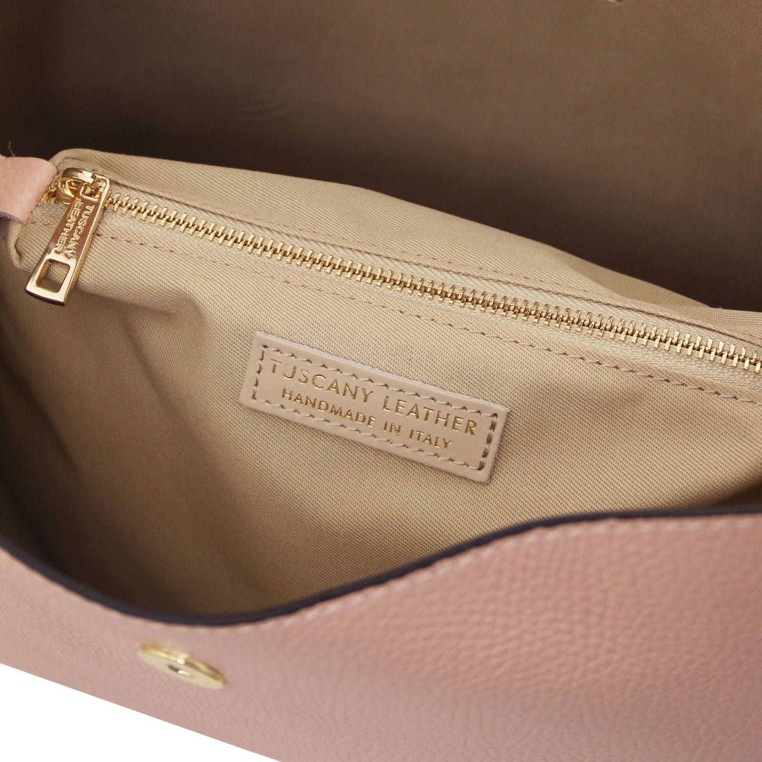 Beige pebbled leather bucket bag interior with a gold zipper and Tuscany Leather Handmade in Italy label