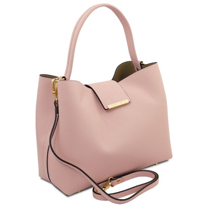 Soft pink pebbled leather Clio bucket bag with top handle and removable strap; gold hardware.