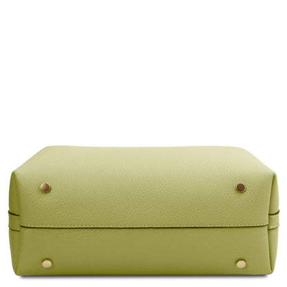 Lime green pebbled leather bucket bag bottom with four gold stud feet