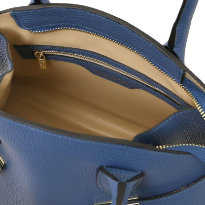 Blue leather tote interior with beige lining and gold zippered pocket