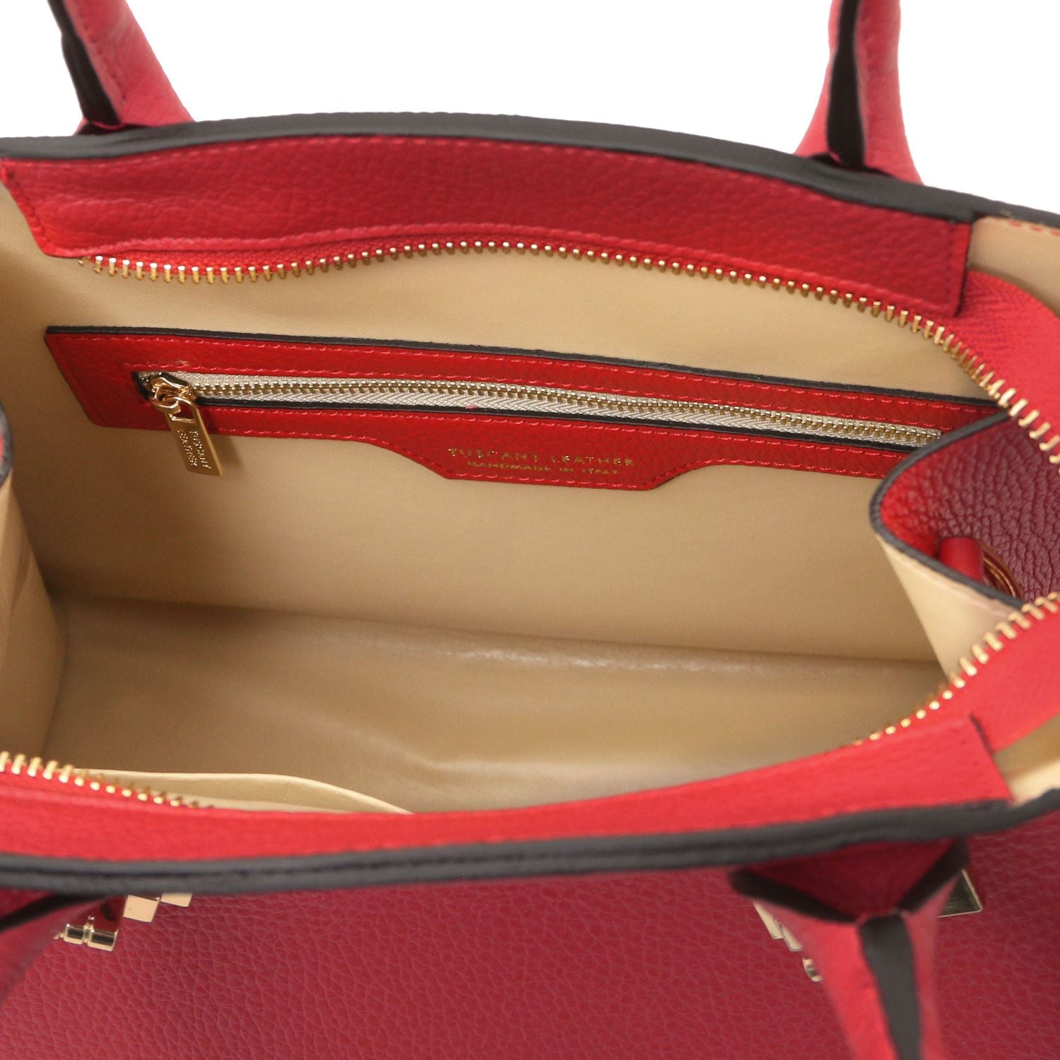 Interior of red Coccola leather tote showing beige lining and gold zip pocket