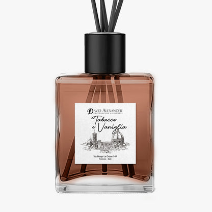 Tabacco e Vaniglia room diffuser in a square glass bottle with pink liquid, reeds and a black cap